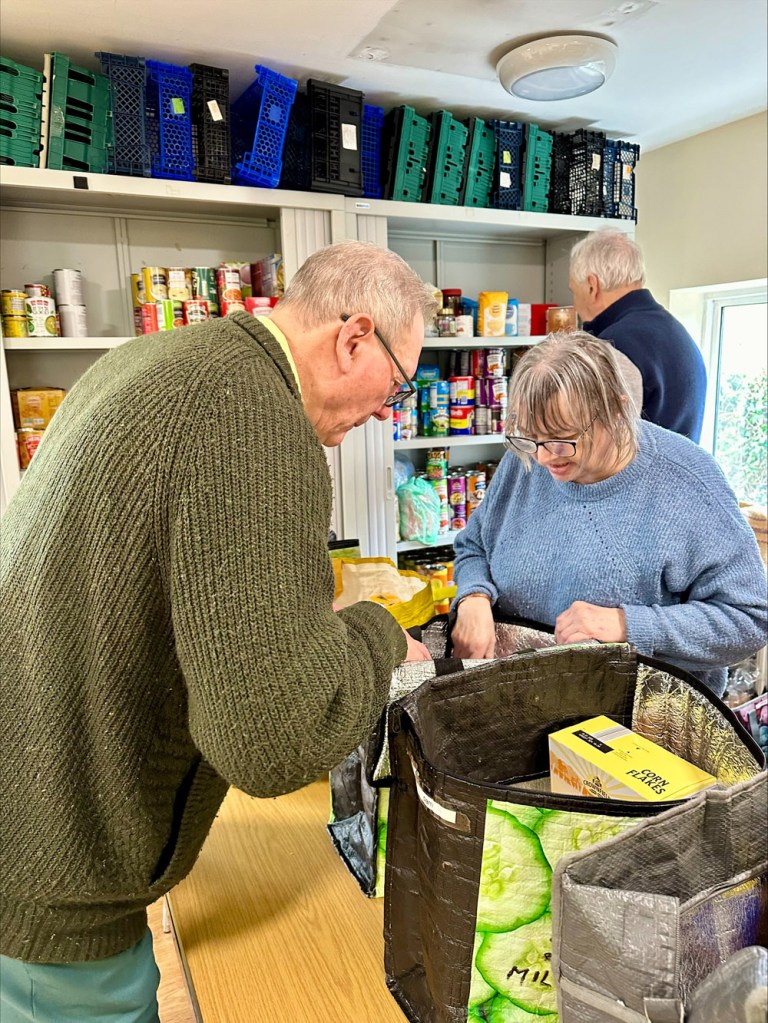 Volunteers making up food bags at Poets Pantry